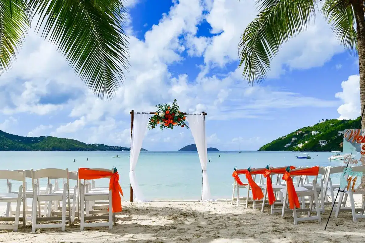 Beachside wedding ceremony setup in St. Thomas under palm trees